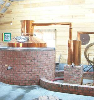 a brick fountain in a building with a barrel