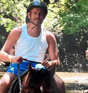 a man is riding a horse in the water
