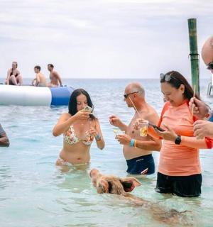 a group of people in the water with a dog