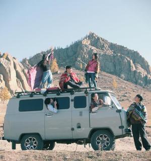 a group of people standing on top of a vehicle