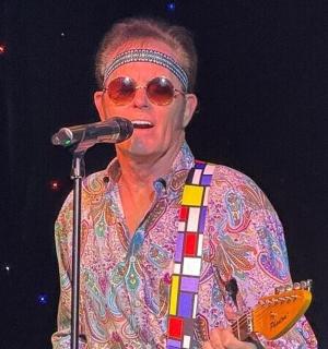 a man singing into a microphone on a stage