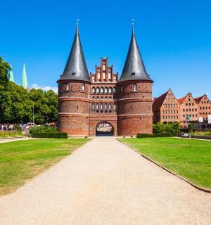 a castle with two towers on top of a grass field