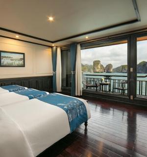 a bedroom with a bed with a view of the water