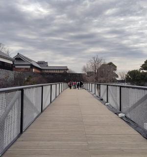 a bridge over a river with people walking on it