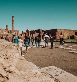 a group of people walking around an ancient ruins