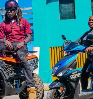 a man and a woman sitting on a motorcycle