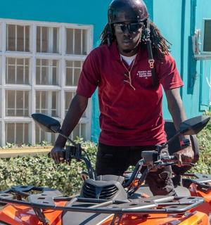 a man is standing next to a motorcycle