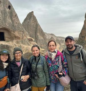 a group of people standing in front of some rocks