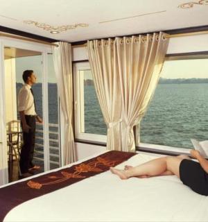 a woman laying on a bed in a room with a window