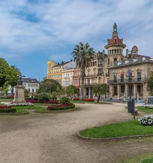 a large building with a park in front of it