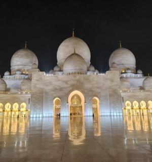 a large white building with domes at night