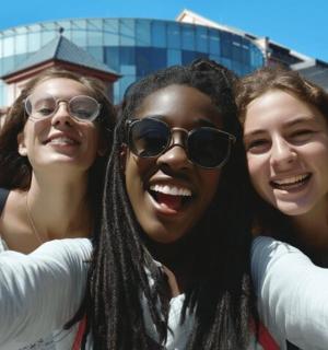 a group of three women posing for a picture