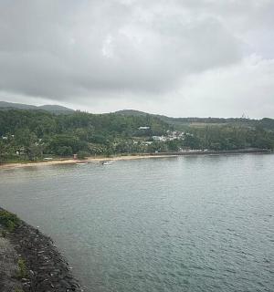 a large body of water with a beach and a road