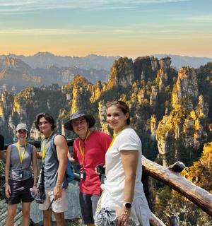 a group of people standing at the top of a mountain