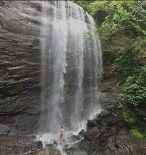 a person standing in front of a waterfall