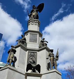 a monument with statues on top of a building