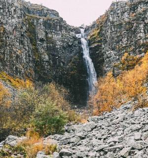 a waterfall on the side of a mountain