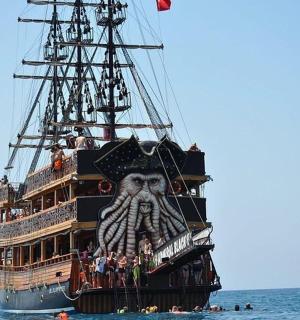a pirate ship in the ocean with people on it