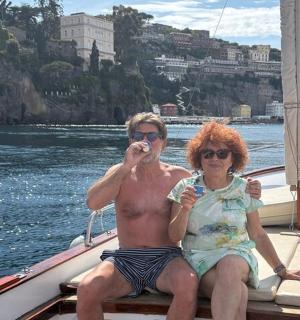 a man and a woman sitting on a boat
