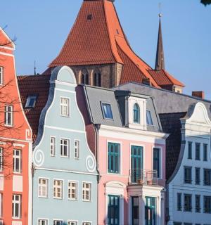 a group of buildings with a church in the background