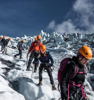 a group of people hiking on a mountain in the snow