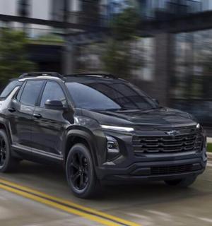 a black truck driving down a street