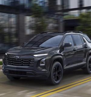 a black truck driving down a city street