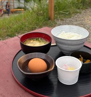 a black plate with bowls of food on a table