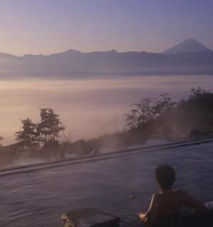 a boy sitting in a swimming pool looking at the water