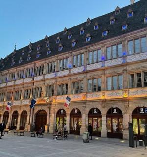 a large building with people sitting outside of it