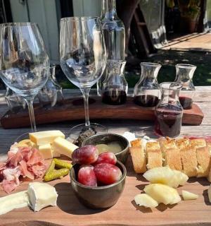 a table with wine glasses and cheese and bread