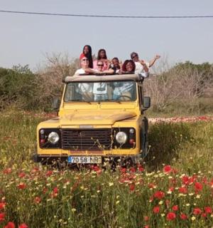 a group of people riding on the back of a yellow truck