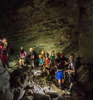 a group of people standing in a cave