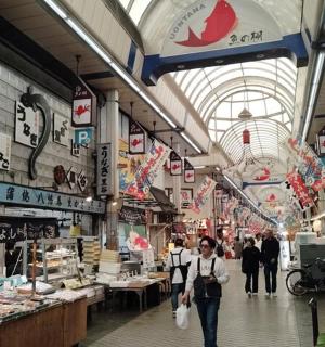 一名男子穿过市场，其他人也穿过市场