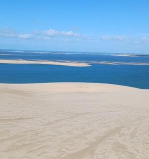 an aerial view of the sand dunes and the ocean