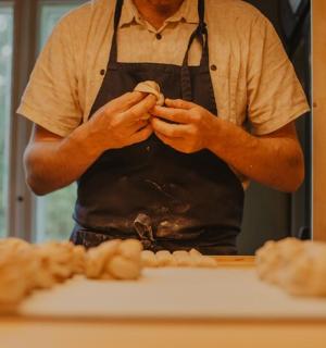 a man in an apron is making food