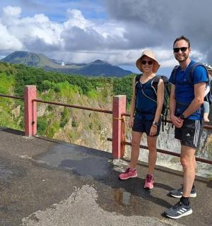 a man and a woman standing on top of a mountain