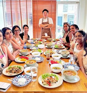 a group of people sitting at a table eating food