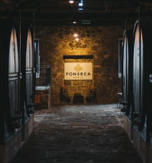 a dark hallway with a door in a brick wall