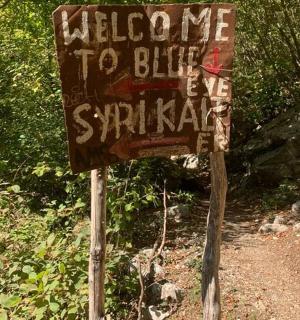 a sign on the side of a dirt road