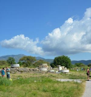 a group of people walking around the ruins