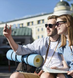 a man and a woman sitting on a motorcycle