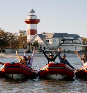 a group of people are riding on rafts in the water