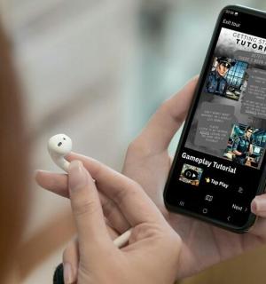 a person holding a white ball and a remote control