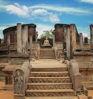 a large building with stairs and a statue in it