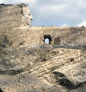 a rock cliff with a face on top of it
