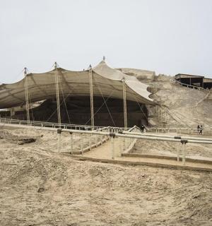 a large tent on top of a dirt hill