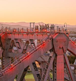 a group of people standing on a red bridge