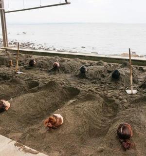 a sand castle on the beach with chickens in it