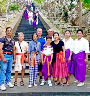 a group of people posing for a picture in front of some stairs